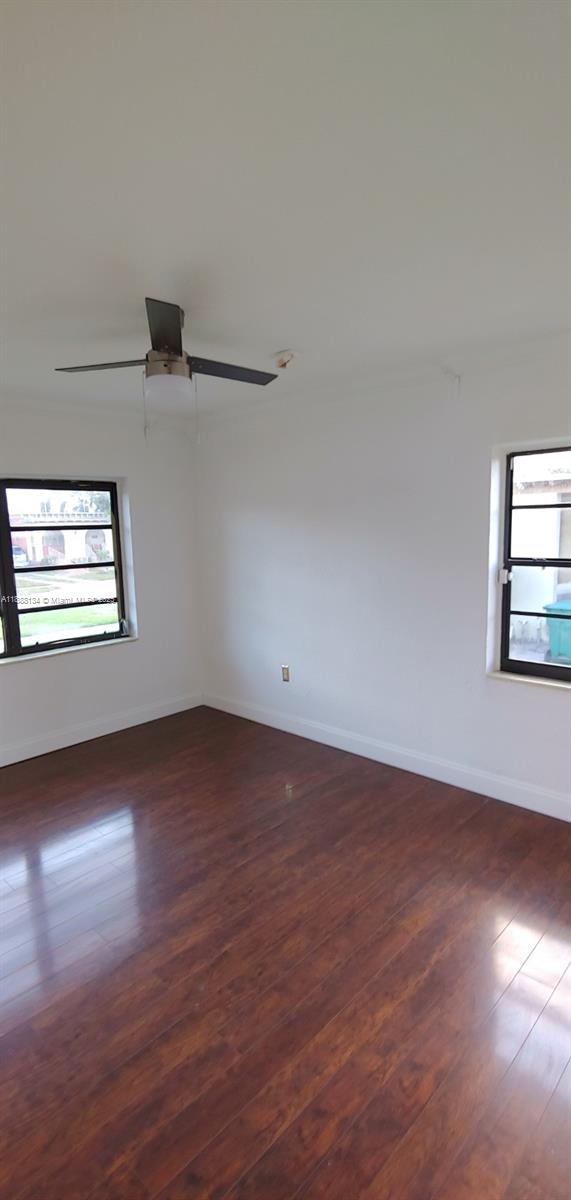 5770 Southwest 62nd Terrace Miami, FL 33143 - Photo 10 of 17 an empty room with wooden floor cabinet and windows