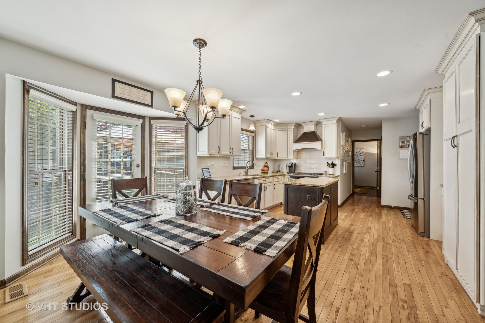 2310 Forest Ridge Road St. Charles, IL 60174 - Photo 8 of 23 a living room with kitchen island furniture and a chandelier