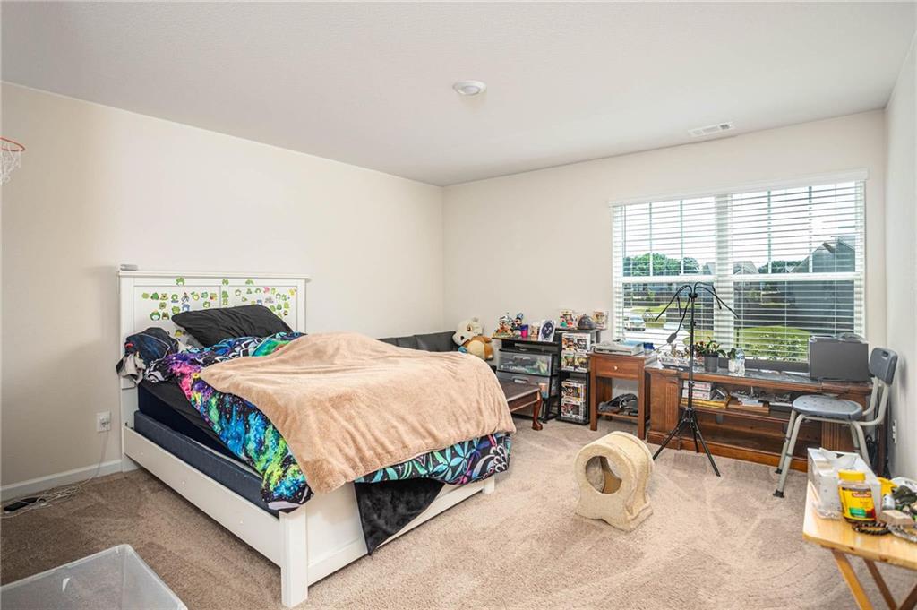 635 Meadows Farm Way Monroe, GA 30655 - Photo 26 of 36 a bedroom with a bed table and chairs