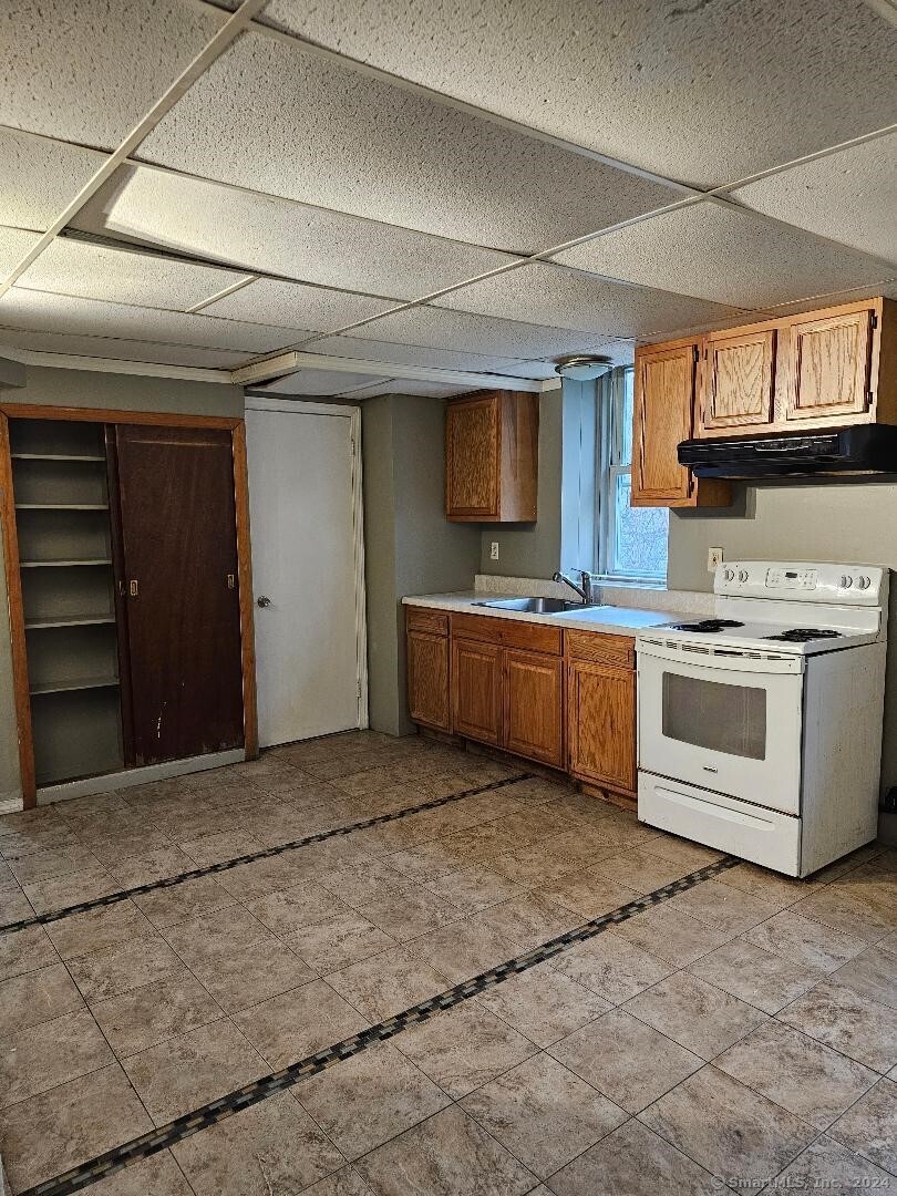 a kitchen with a stove top oven and cabinets