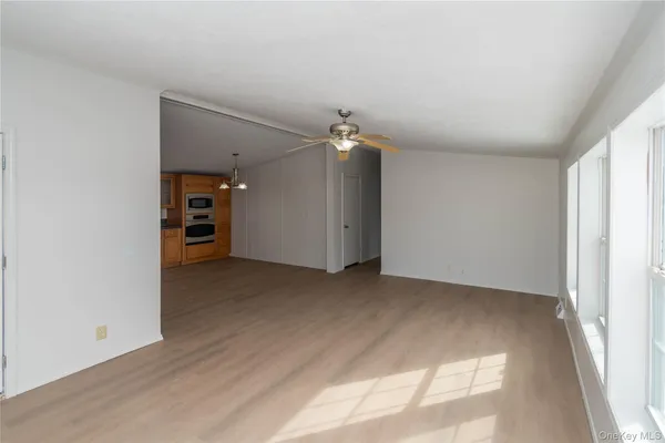 an empty room with closet and a window