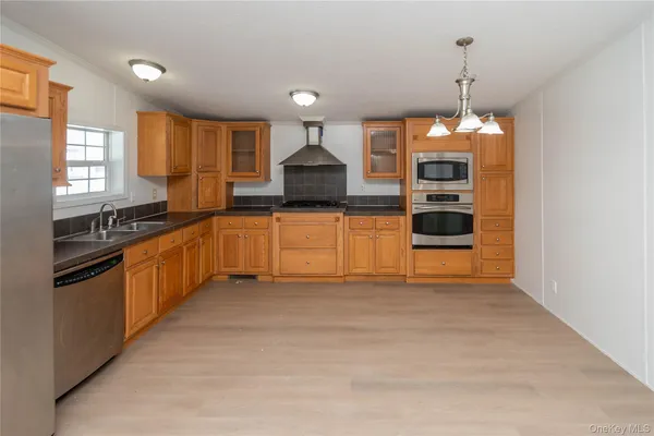 a kitchen with stainless steel appliances granite countertop a stove and a sink