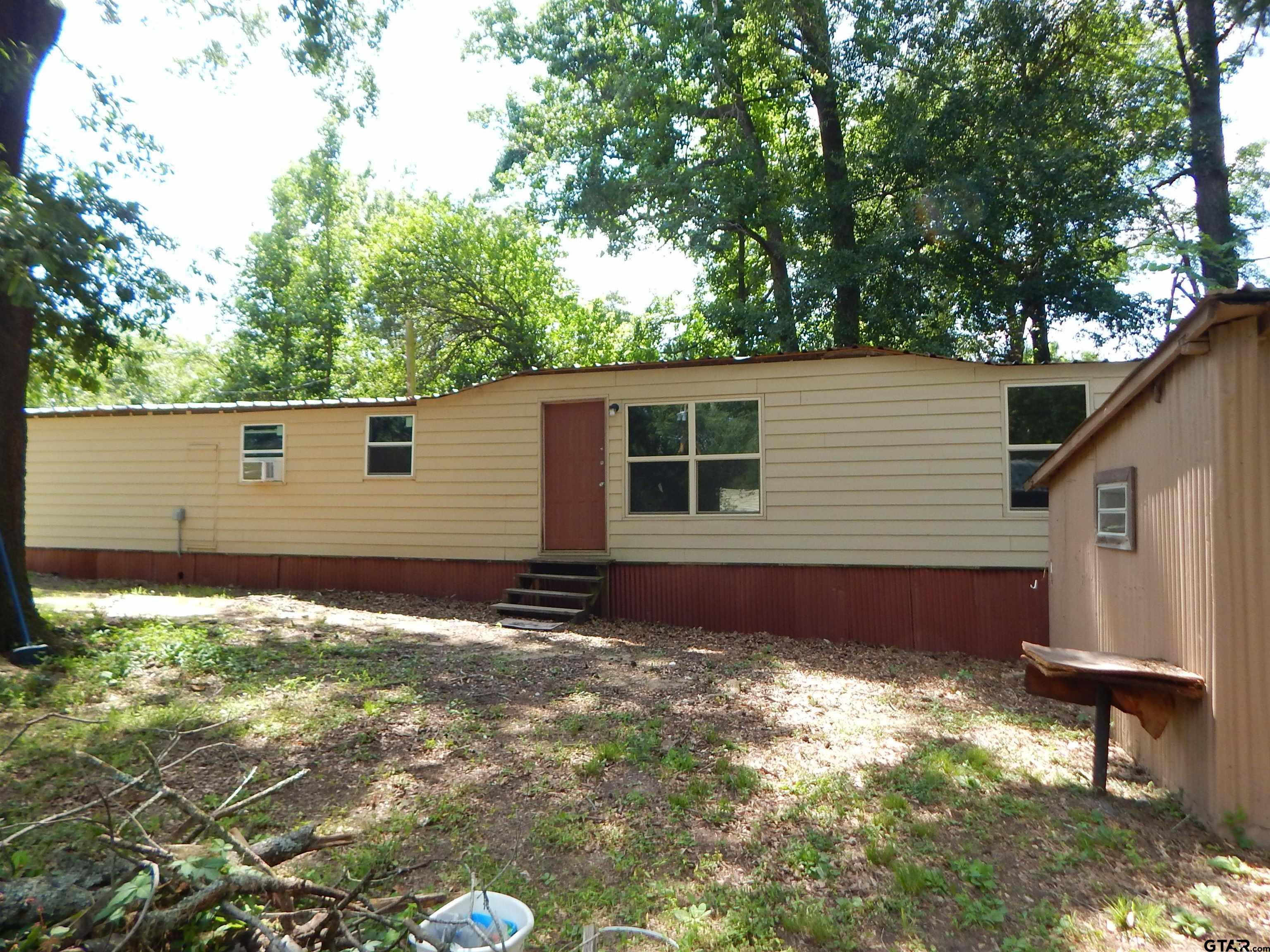 214 Lawrence Street Gilmer, TX 75644 - Photo 3 of 11 a backyard of a house