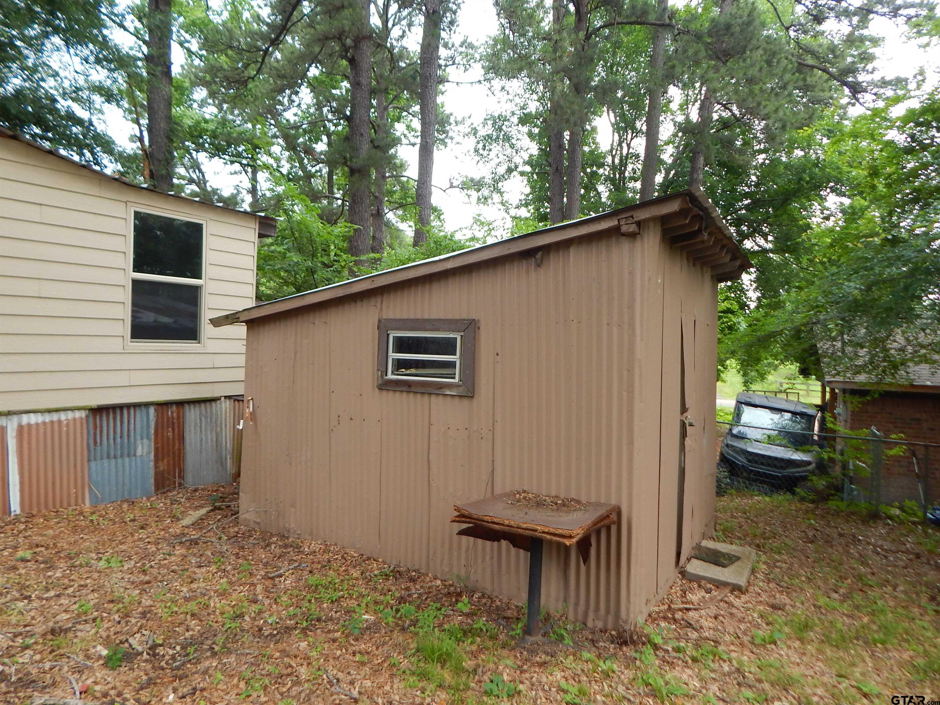 214 Lawrence Street Gilmer, TX 75644 - Photo 4 of 11 a backyard of a house with table and chairs