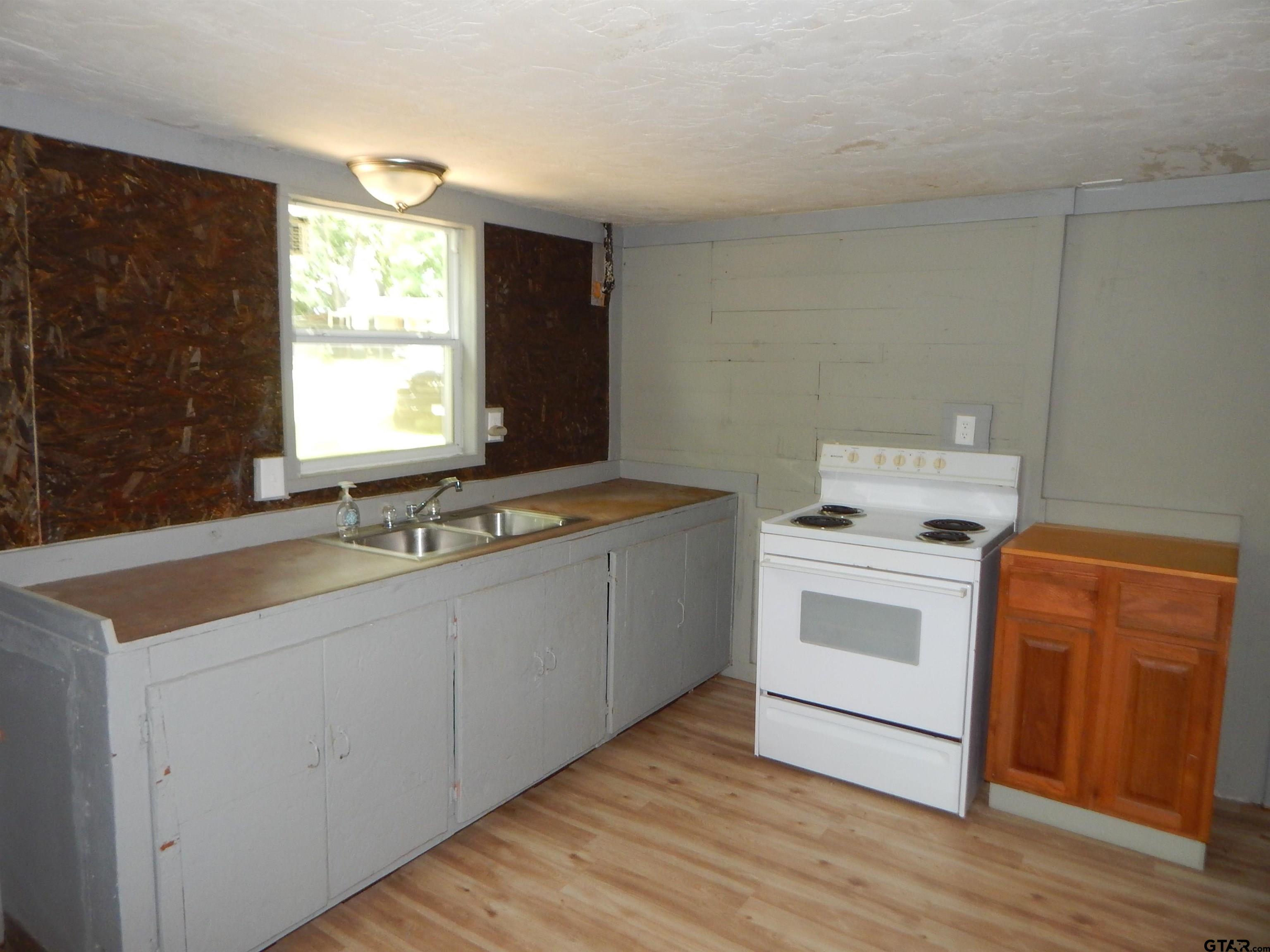 214 Lawrence Street Gilmer, TX 75644 - Photo 6 of 11 a utility room with cabinets washer and dryer