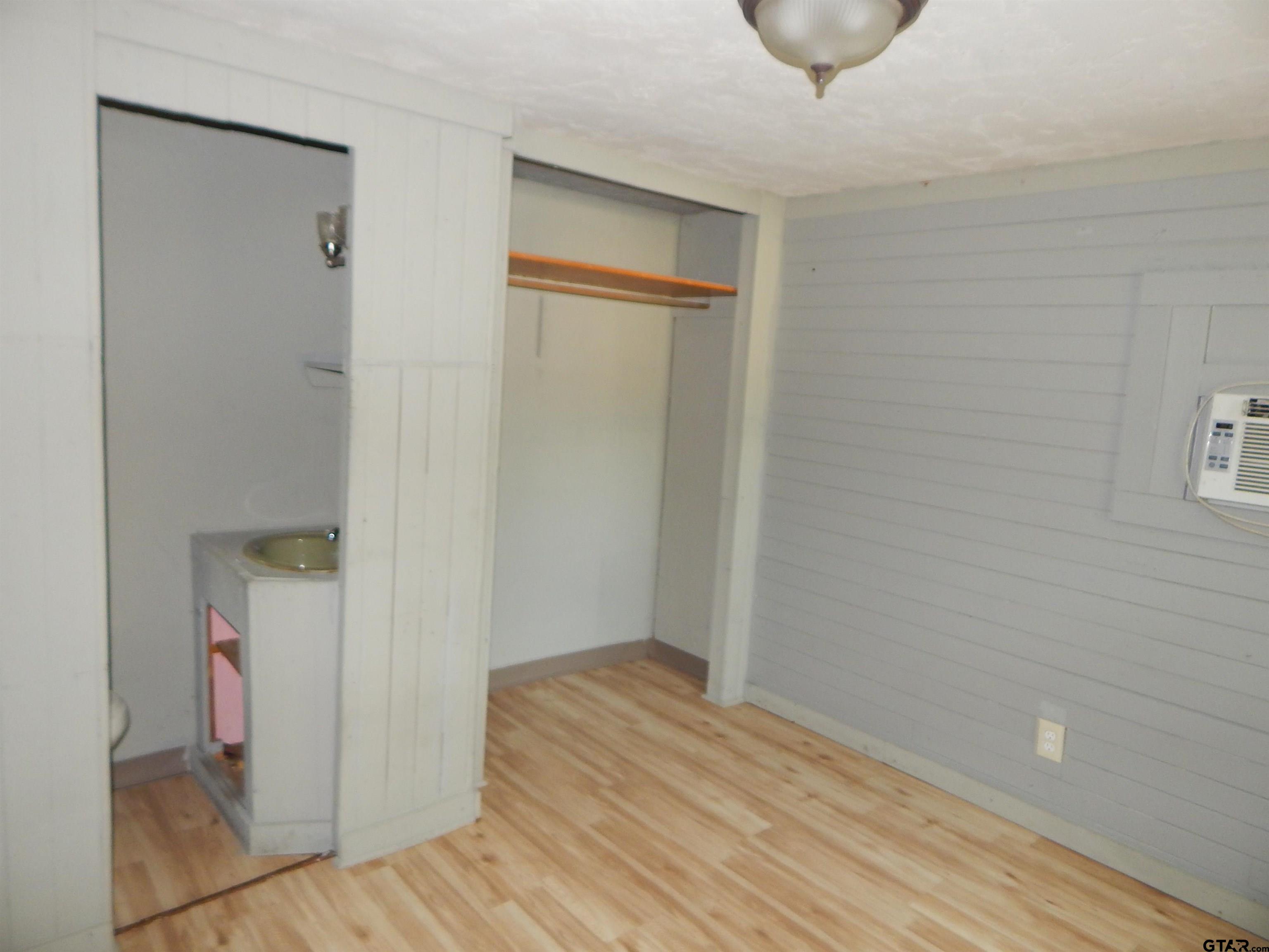 214 Lawrence Street Gilmer, TX 75644 - Photo 10 of 11 a view of hallway with wooden floor