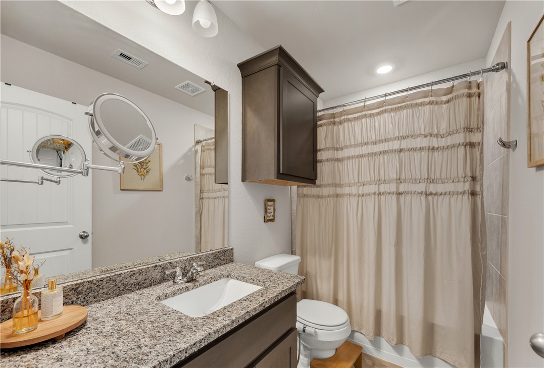 2016 Chief Street Bryan, TX 77807 - Photo 24 of 30 a bathroom with a granite countertop sink toilet and shower
