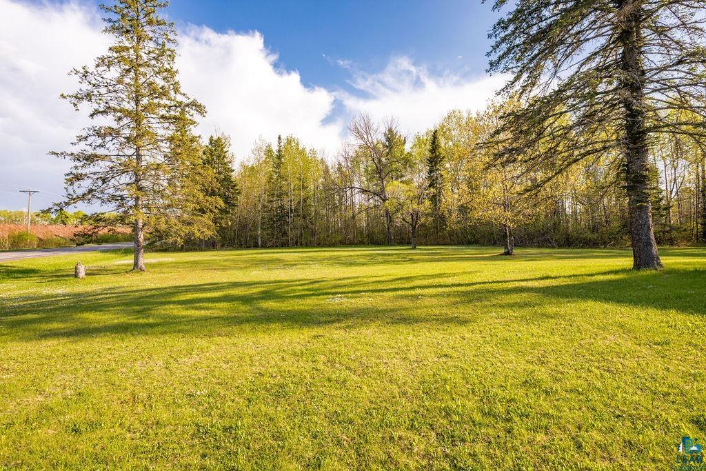 4543 County Road East South Range, WI 54874 - Photo 34 of 43 Expansive grassy lawn with scattered mature trees and a wooded perimeter