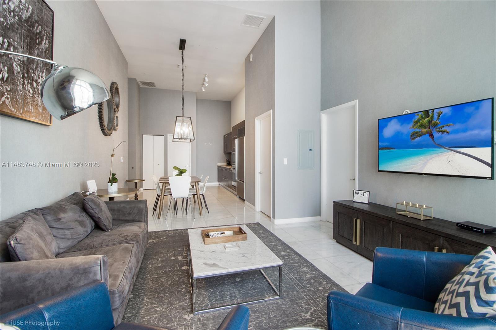 Brickell Miami, FL 33131 - Photo 3 of 10 a living room with furniture and a flat screen tv