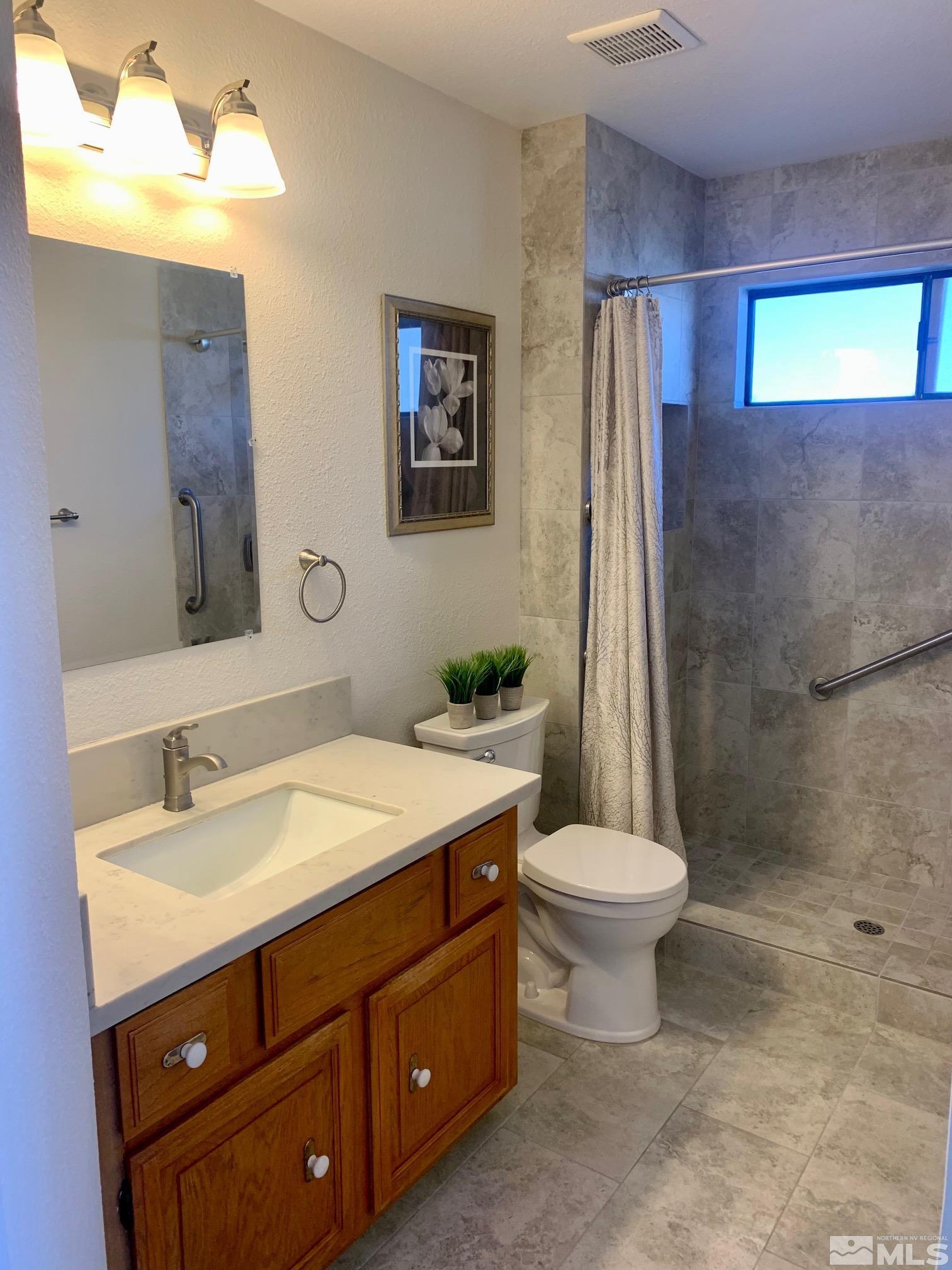 3070 Bramble Drive Reno, NV 89509 - Photo 11 of 23 a bathroom with a sink toilet and shower