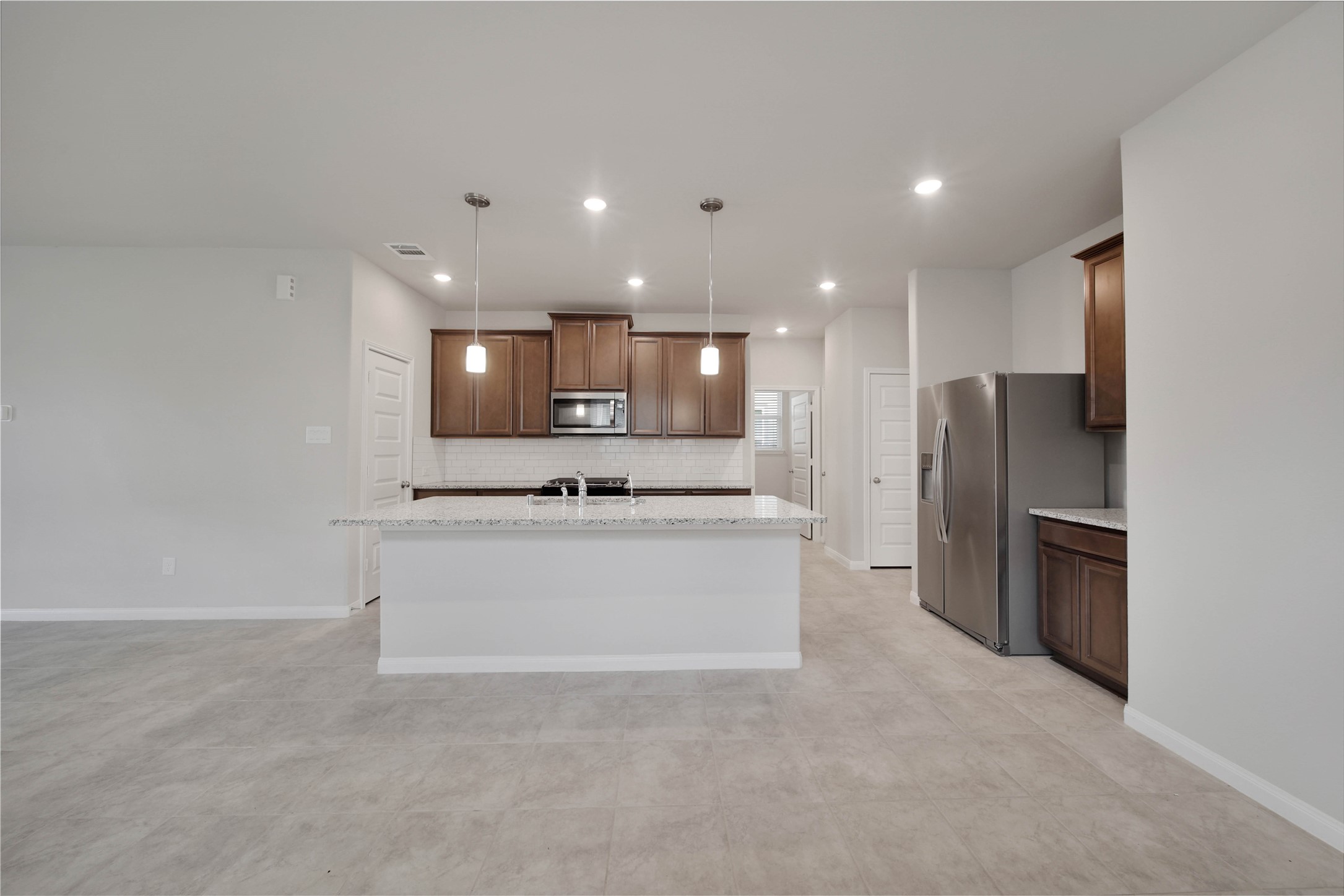 7080 Silverleaf Oak Street Conroe, TX 77304 - Photo 6 of 35 A Dupure filtered drinking water tap at the sink, stainless steel appliances, outlets with USB plugs, and a spacious step-in pantry are some more features to love in this kitchen. There’s also a tankless water heater.