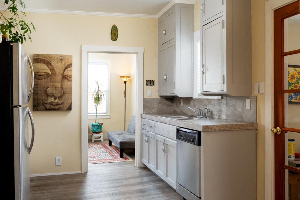 2211 Capitola Road Santa Cruz, CA 95062 - Photo 7 of 20 a en suite bathroom with a granite countertop sink and a mirror