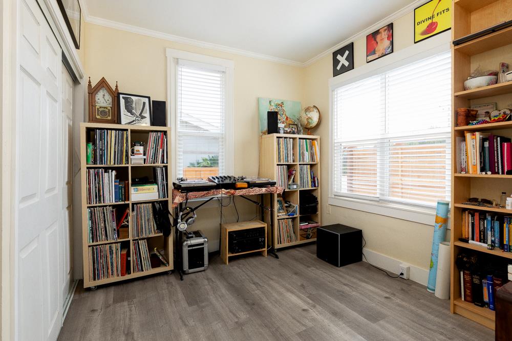 2211 Capitola Road Santa Cruz, CA 95062 - Photo 8 of 20 a livingroom with a bookshelf and a workspace