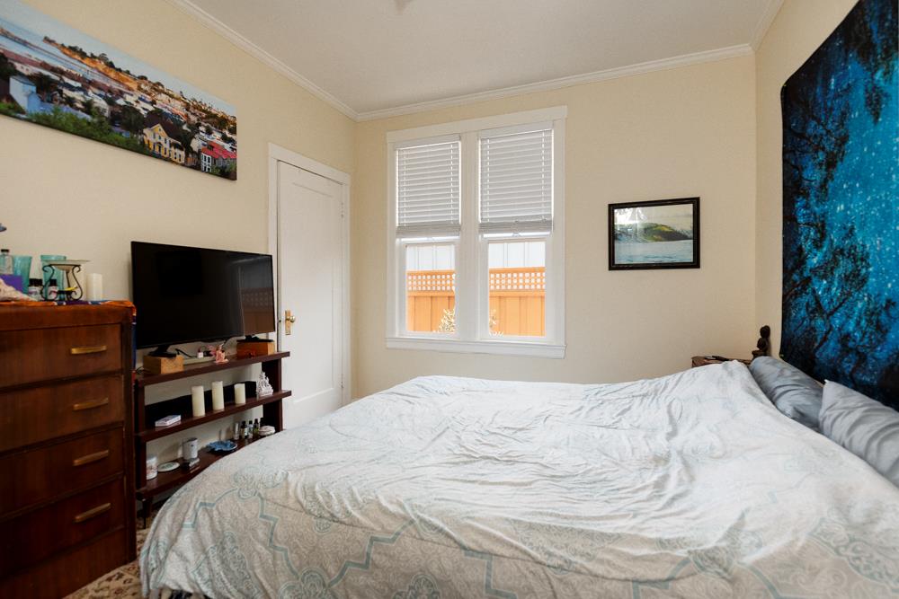 2211 Capitola Road Santa Cruz, CA 95062 - Photo 9 of 20 a bedroom with a bed and a flat screen tv