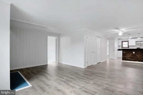a view of an empty room with wooden floor