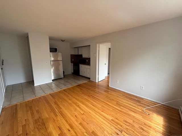 a view of a kitchen with a sink and a refrigerator