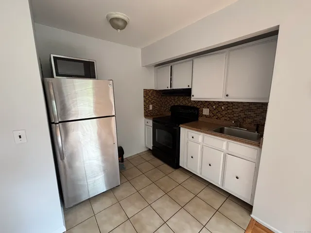 a kitchen with a refrigerator and a stove