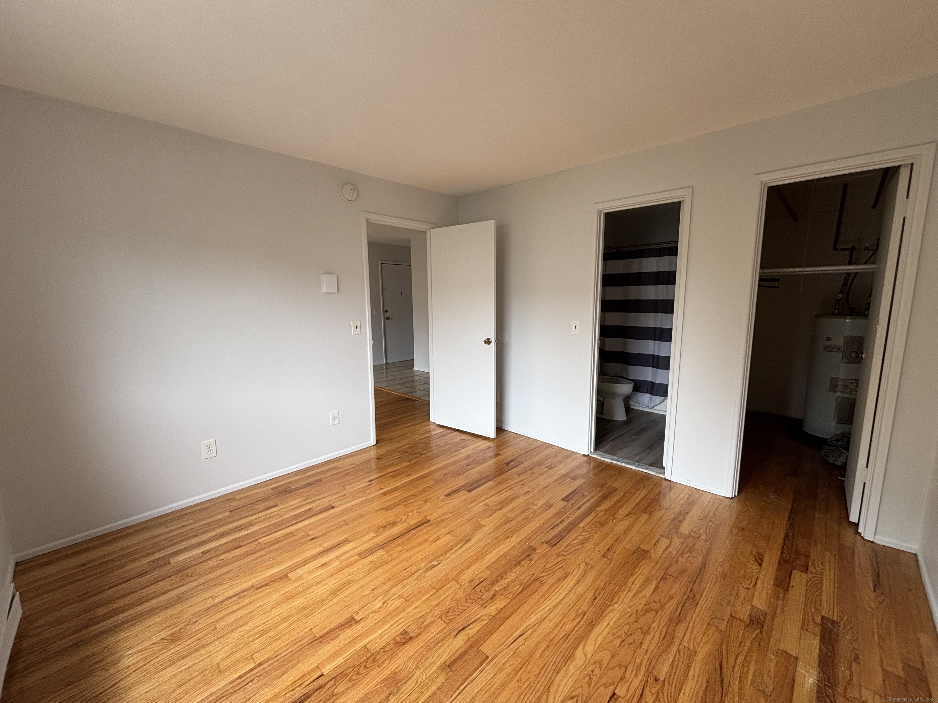 17 Ferris Avenue, Unit 21 Norwalk, CT 06854 - Photo 7 of 8 a view of a bedroom with wooden floor and closet