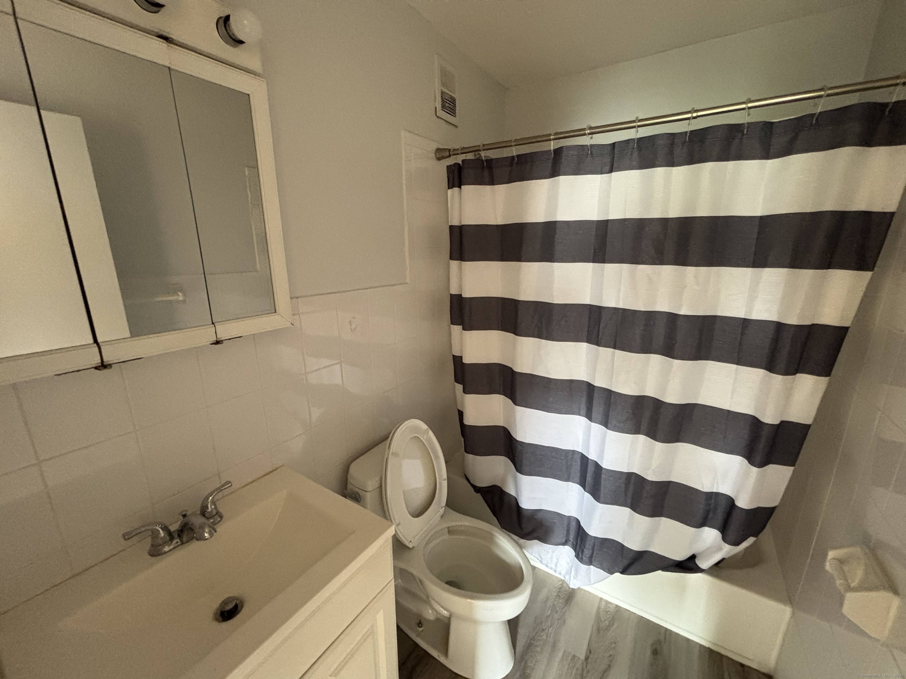 17 Ferris Avenue, Unit 21 Norwalk, CT 06854 - Photo 8 of 8 a bathroom with a sink toilet and shower