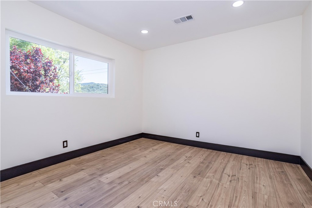 42640 Ranch Club Road Lake Hughes, CA 93532 - Photo 9 of 27 a view of an empty room with wooden floor and a window