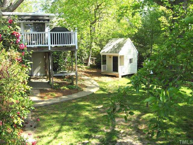 2400 Ridge Road Raleigh, NC 27612 - Photo 12 of 12 Spacious fenced back yard with playhouse, irrigation system, & gorgeous landscaping