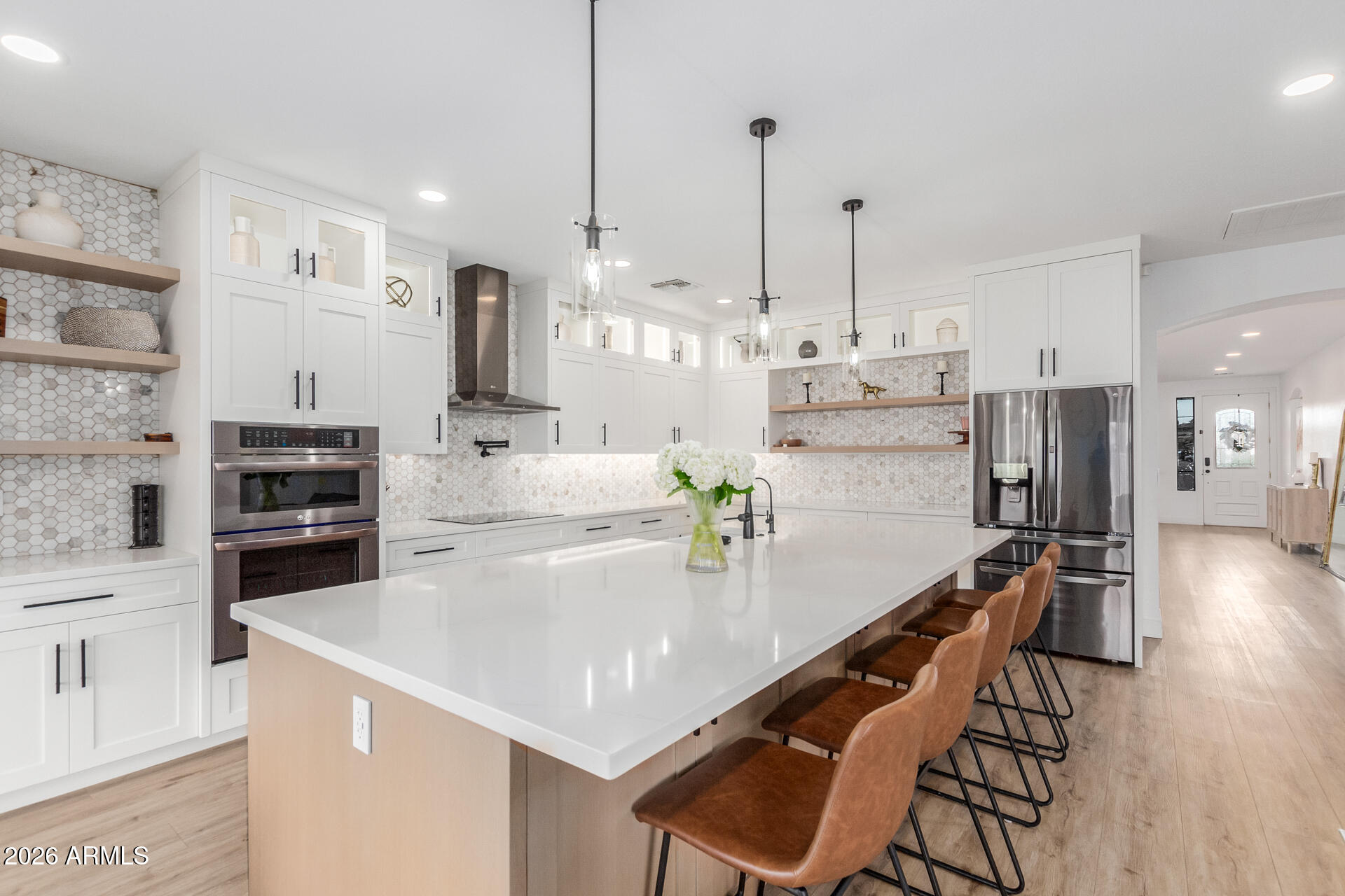 6404 West Black Hill Road Phoenix, AZ 85083 - Photo 11 of 33 a kitchen with stainless steel appliances kitchen island granite countertop a table chairs stove and refrigerator