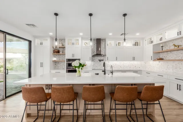 a view of dining table chairs and chandelier