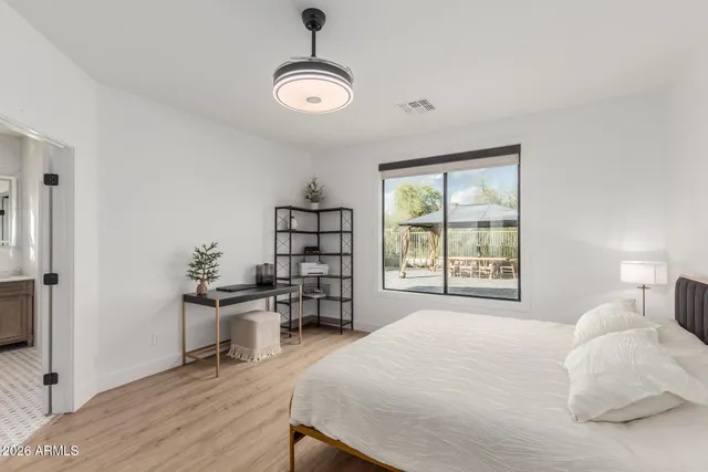 a bedroom with a bed and a table in it