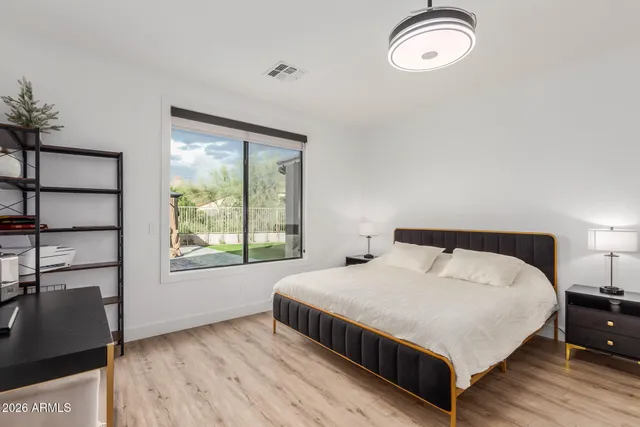 a bedroom with a bed and a window