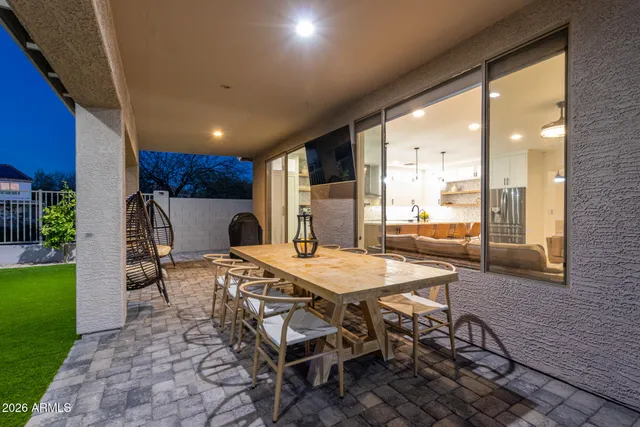 a dinning table and chairs in patio of the house