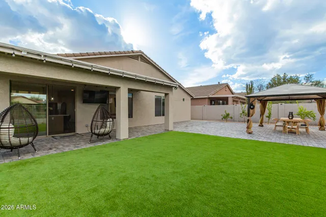 a view of a house with backyard porch and sitting area