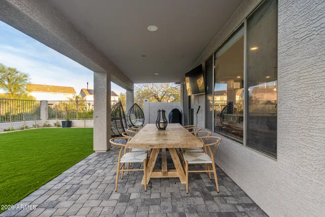 a view of a patio with a table chairs and a backyard