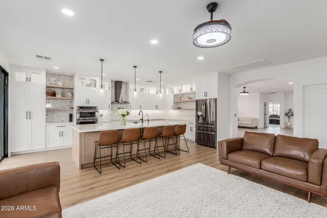 a large kitchen with a table and chairs