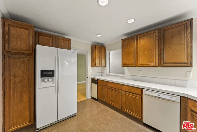 a kitchen with stainless steel appliances a refrigerator sink and cabinets