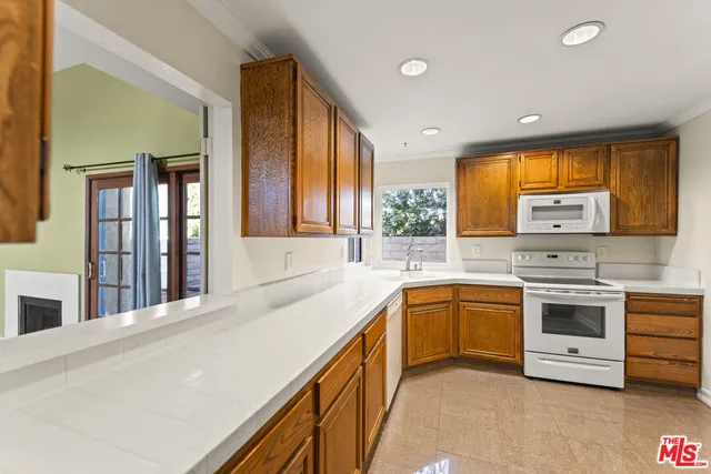 a kitchen with stainless steel appliances granite countertop a sink and cabinets