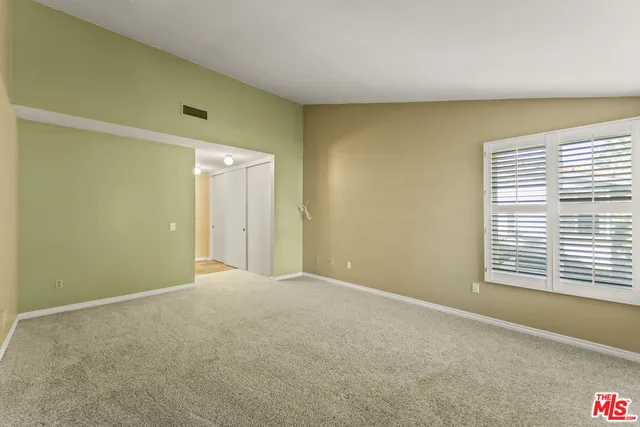 a bedroom with a large bed and potted plant