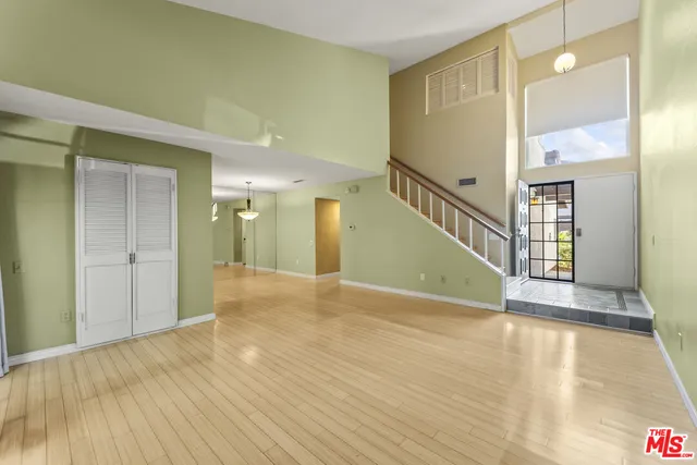 a view of an entryway with wooden floor