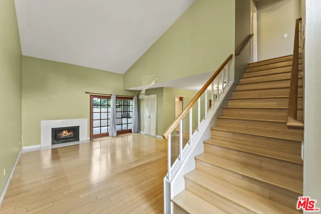 a view of an entryway with wooden floor and a rug