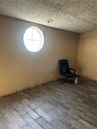 a view of room with wooden floor and white walls