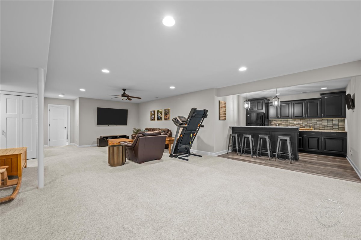 1909 Constitution Street Sycamore, IL 60178 - Photo 18 of 39 a living room with furniture a flat screen tv and kitchen view