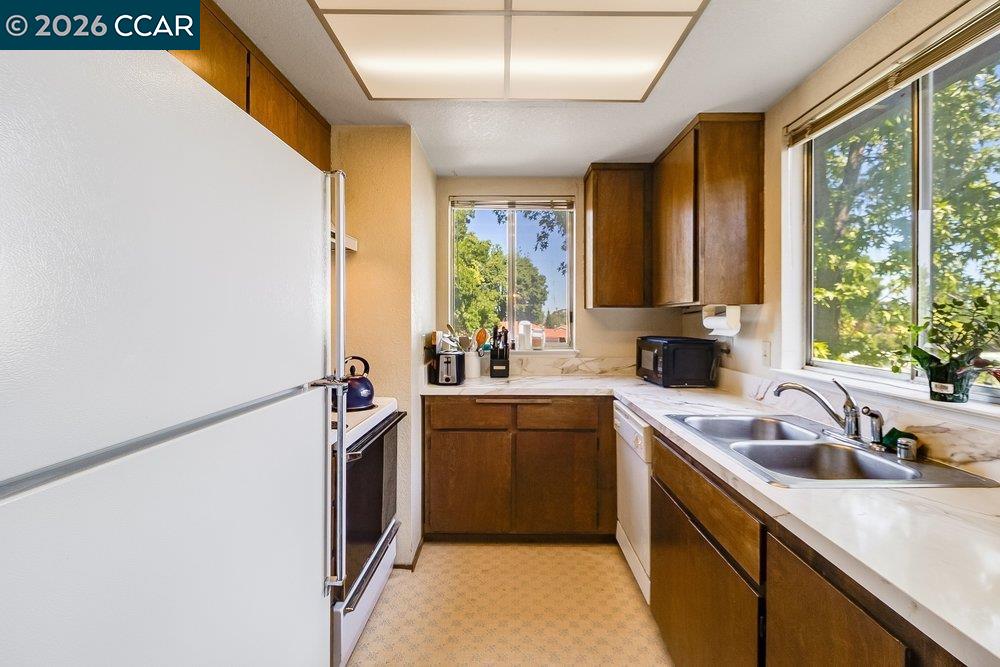 1123 Chadwick Circle Bay Point, CA 94565 - Photo 11 of 26 a kitchen with a sink stove and refrigerator