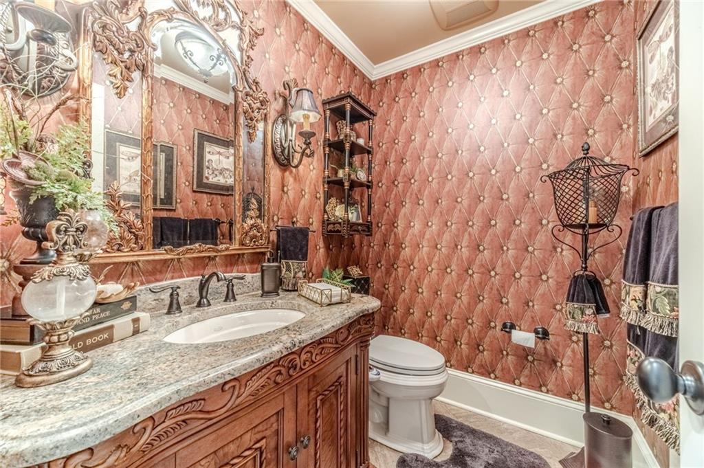 1600 Beagle Run Monroe, GA 30656 - Photo 57 of 103 a bathroom with a granite countertop sink a toilet and a shower curtain