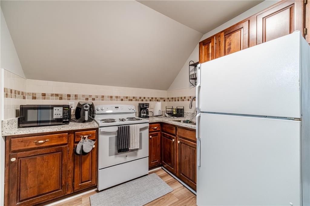 1600 Beagle Run Monroe, GA 30656 - Photo 70 of 103 a kitchen with stainless steel appliances granite countertop a refrigerator a stove a sink and a microwave