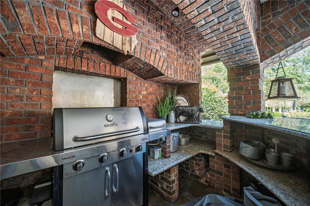 1600 Beagle Run Monroe, GA 30656 - Photo 78 of 103 a kitchen with stainless steel appliances granite countertop a sink a stove and a wooden cabinets