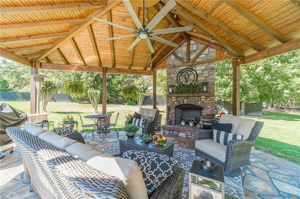 1600 Beagle Run Monroe, GA 30656 - Photo 87 of 103 a living room with furniture a fireplace and a floor to ceiling window