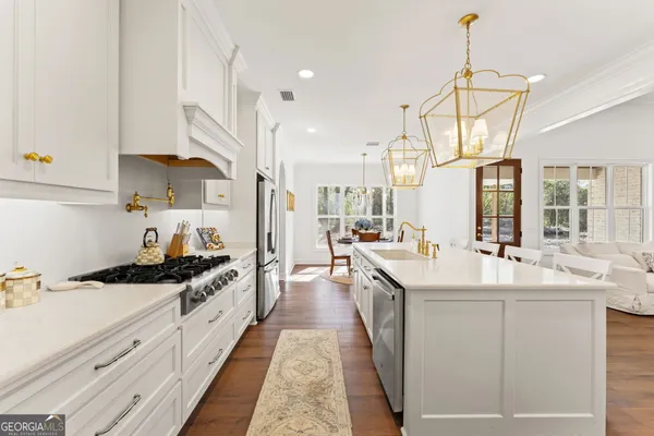 a kitchen with sink stove and cabinets