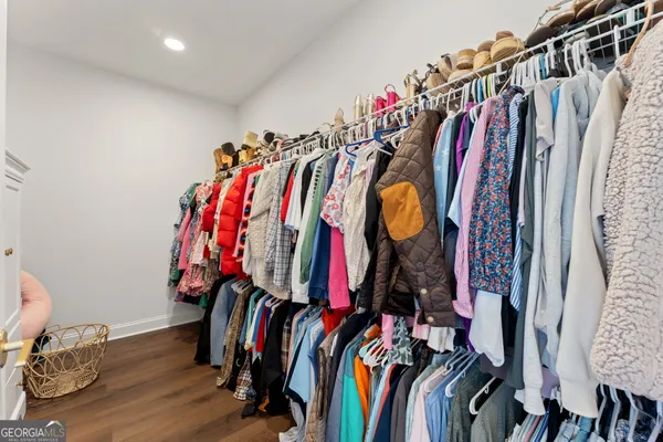 a view of walk in closet with clothes