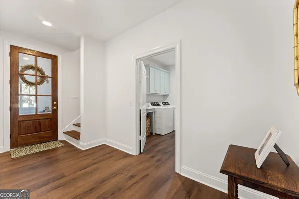 a view of a workspace with wooden floor and furniture