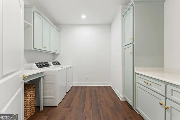 a view of storage and utility room with wooden floor