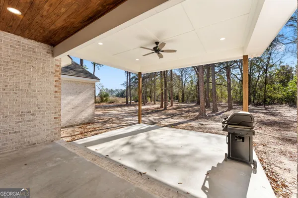 a view of a patio with a table and chairs